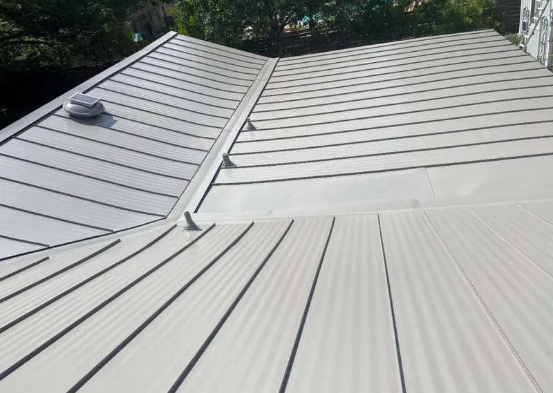 Solar attic fan installed on a metal roof for Roof Ventilation in Woodstock